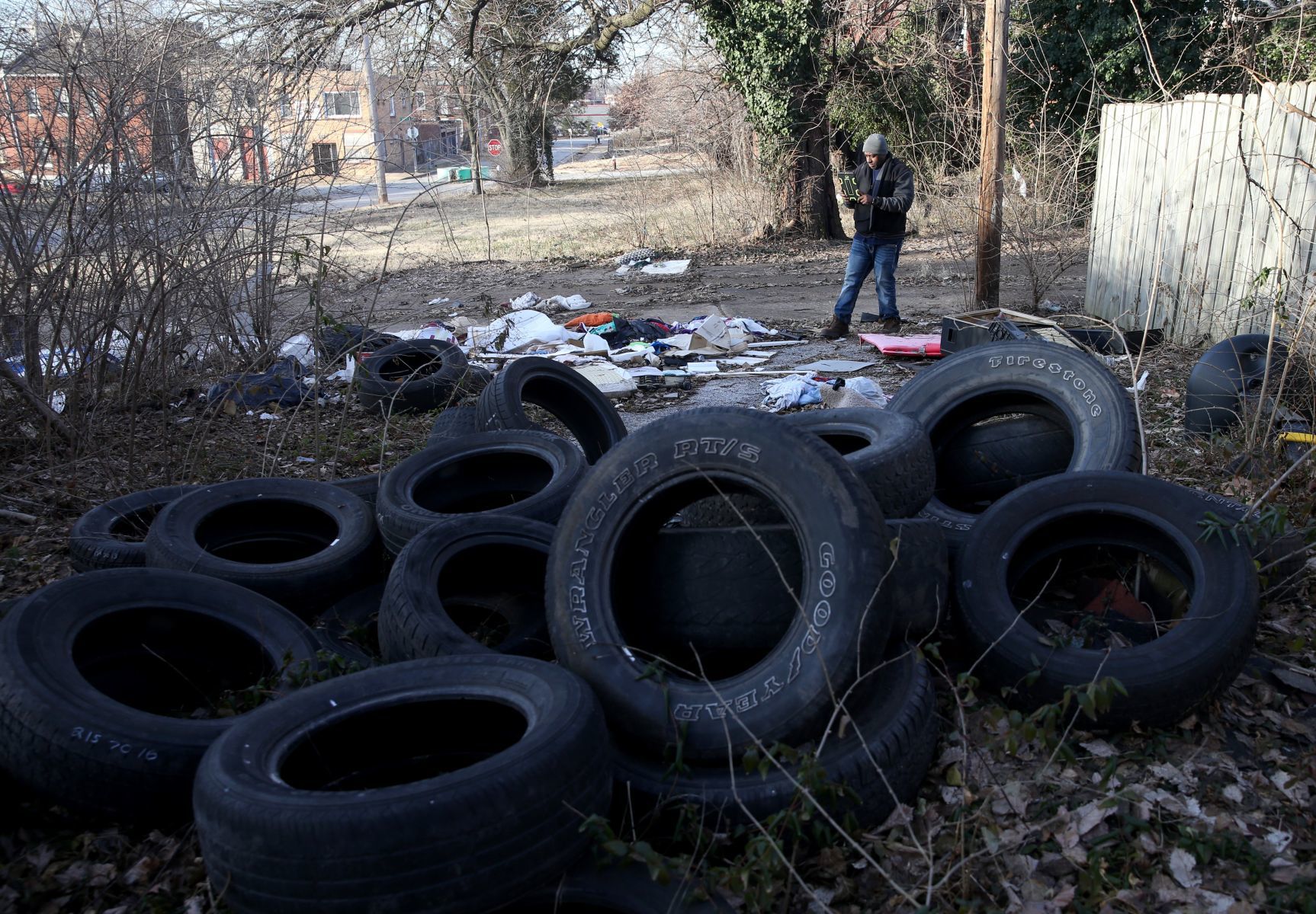 Foreman Tony Stokes documents illegally dumped trash and debris with his tablet